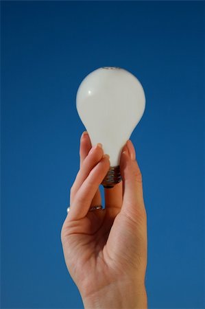 simsearch:400-04901392,k - A female's hand holding a lightbulb against a blue sky Stock Photo - Budget Royalty-Free & Subscription, Code: 400-04648207
