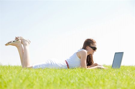 simsearch:6109-06003526,k - A cute young female lying on the grass in the park using a laptop Stock Photo - Budget Royalty-Free & Subscription, Code: 400-04648266