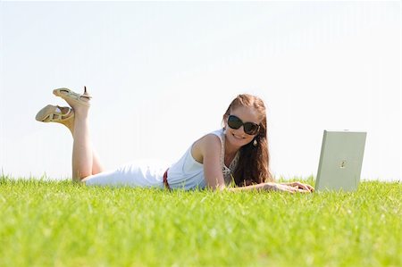 simsearch:6109-06003526,k - A cute young female lying on the grass in the park using a laptop Stock Photo - Budget Royalty-Free & Subscription, Code: 400-04648267