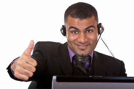 simsearch:400-03985399,k - Call center agent wearing a headset and expressing happiness by showing thumb up. Photographie de stock - Aubaine LD & Abonnement, Code: 400-04648547