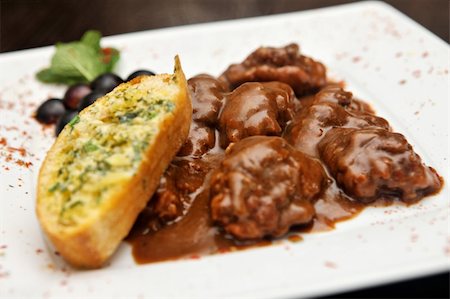 steak and cheese - brown meat in sauce with garlic bread and grapes Stock Photo - Budget Royalty-Free & Subscription, Code: 400-04648558