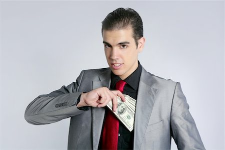 Businessman young with dollar notes suit and tie on gray background Stock Photo - Budget Royalty-Free & Subscription, Code: 400-04649188