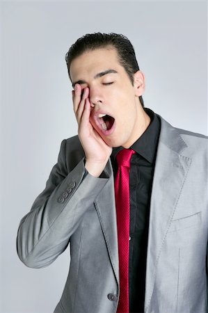 simsearch:400-04204942,k - Businessman yawn boring on gray background with suit and red tie Stock Photo - Budget Royalty-Free & Subscription, Code: 400-04649194
