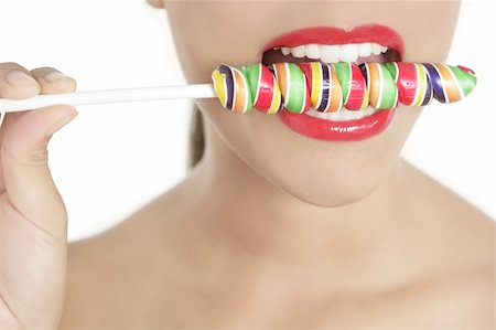 simsearch:400-04575822,k - Colorful Lollypop in perfect woman teeth and red lips mouth Photographie de stock - Aubaine LD & Abonnement, Code: 400-04649229