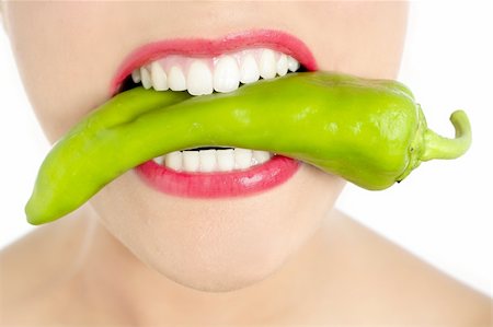 simsearch:400-04575822,k - Beautiful woman teeth eating green vegetable raw pepper Photographie de stock - Aubaine LD & Abonnement, Code: 400-04649234