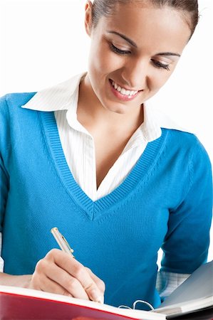 Beautiful female student writing something, isolated on white Stock Photo - Budget Royalty-Free & Subscription, Code: 400-04649500