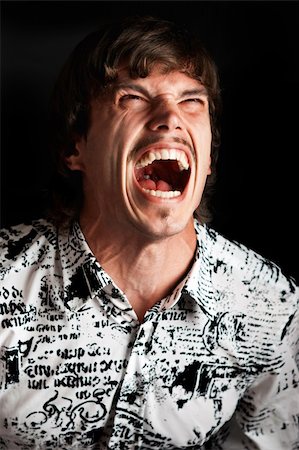 simsearch:400-04554224,k - Portrait of a young man screaming out loud against black background Stock Photo - Budget Royalty-Free & Subscription, Code: 400-04649942