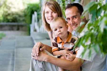 Happy perfect young family with dad, mom and son outdoors having fun Stock Photo - Budget Royalty-Free & Subscription, Code: 400-04640788