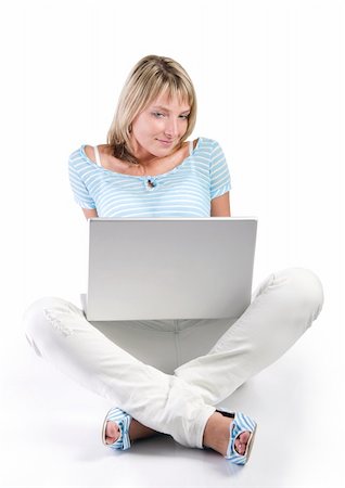 student legs - young woman sitting with laptop, isolated on white Stock Photo - Budget Royalty-Free & Subscription, Code: 400-04640871