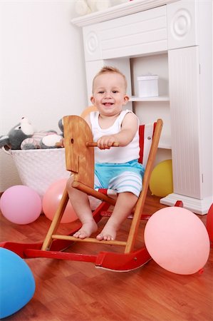 simsearch:400-04658762,k - Cute smilling boy enjoy his rocking horse ride Stockbilder - Microstock & Abonnement, Bildnummer: 400-04641776