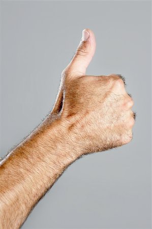 Hairy man hand closeup expression over gray background Stock Photo - Budget Royalty-Free & Subscription, Code: 400-04641847