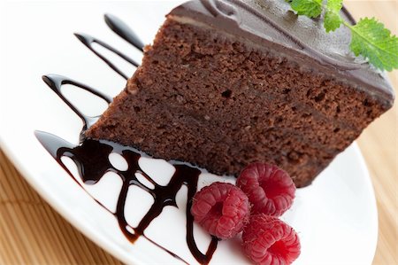 Slice of delicious chocolate cake with raspberries and mint Stock Photo - Budget Royalty-Free & Subscription, Code: 400-04641880
