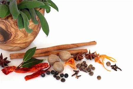 Spice selection and bay herb leaves with fresh sage in an olive wood mortar with pestle, over white background. Stock Photo - Budget Royalty-Free & Subscription, Code: 400-04642043