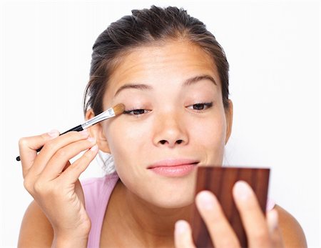 Beautiful mixed asian / caucasian woman putting makeup. Photographie de stock - Aubaine LD & Abonnement, Code: 400-04642699