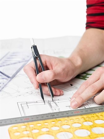 Male architect working on a bluprint, close up on hand and bluprint. Stock Photo - Budget Royalty-Free & Subscription, Code: 400-04643050