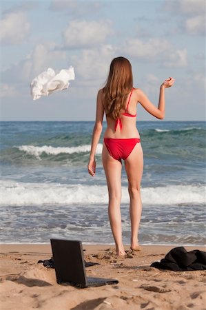 woman in bikinis throwing blouse on the beach Stock Photo - Budget Royalty-Free & Subscription, Code: 400-04643604