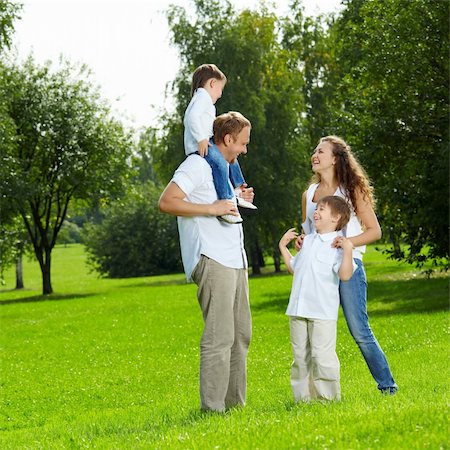 simsearch:400-04654326,k - Laughing family with two sons walks in a summer garden Stock Photo - Budget Royalty-Free & Subscription, Code: 400-04654304