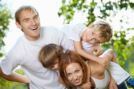 piggyback brothers - Young family from four members has fun in a summer garden Stock Photo - Budget Royalty-Free & Subscription, Code: 400-04654322