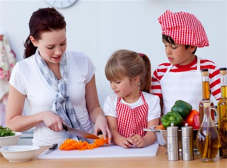 Smiling children helping mother cooking in the kitchen Stock Photo - Budget Royalty-Free & Subscription, Code: 400-04654565