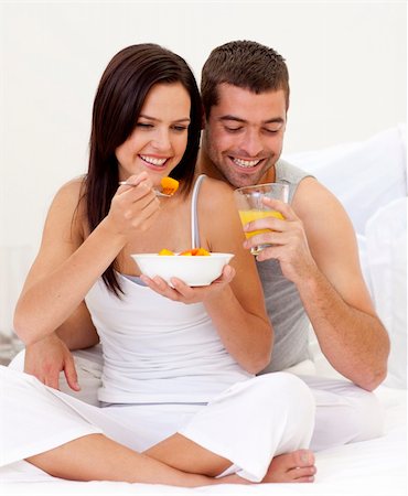 Happy woman and man having nutritive breakfast in bed Stock Photo - Budget Royalty-Free & Subscription, Code: 400-04654600