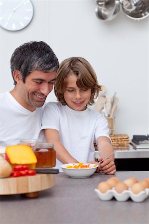 simsearch:400-04791807,k - Smiling father and son having breakfast together in the kitchen Photographie de stock - Aubaine LD & Abonnement, Code: 400-04654822