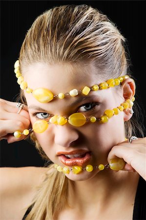 simsearch:400-06103705,k - portrait of blond girl pulling off a yellow stone necklace from her face Foto de stock - Super Valor sin royalties y Suscripción, Código: 400-04654986