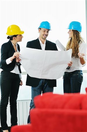 young arhitect group in big bright modern new apartment looking blueprints and building plans Stock Photo - Budget Royalty-Free & Subscription, Code: 400-04655238