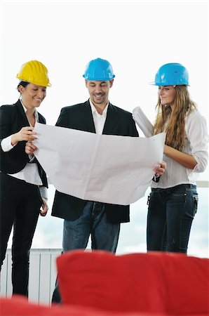 young arhitect group in big bright modern new apartment looking blueprints and building plans Stock Photo - Budget Royalty-Free & Subscription, Code: 400-04655239