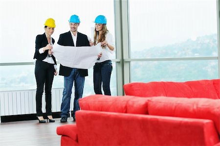 young arhitect group in big bright modern new apartment looking blueprints and building plans Stock Photo - Budget Royalty-Free & Subscription, Code: 400-04655308