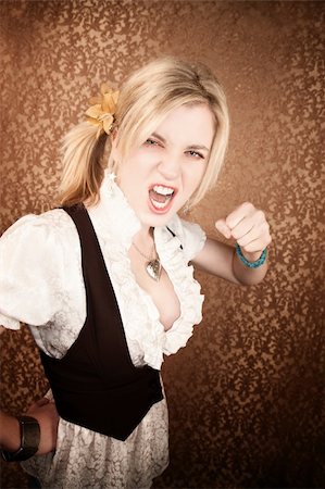 Pretty young blonde girl throwing a punch Stock Photo - Budget Royalty-Free & Subscription, Code: 400-04655484