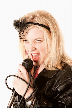 Pretty young female blonde singer or comedian with microphone Stock Photo - Budget Royalty-Free & Subscription, Code: 400-04656201