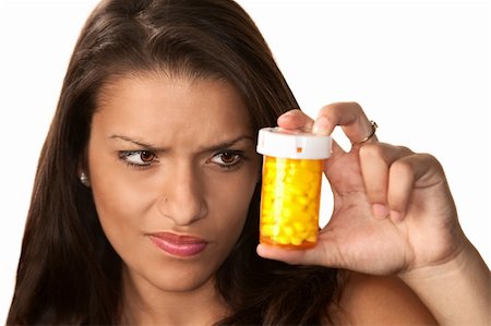 pill bottles girl - Pretty Hispanic woman reading label on prescription medication Stock Photo - Budget Royalty-Free & Subscription, Code: 400-04656768