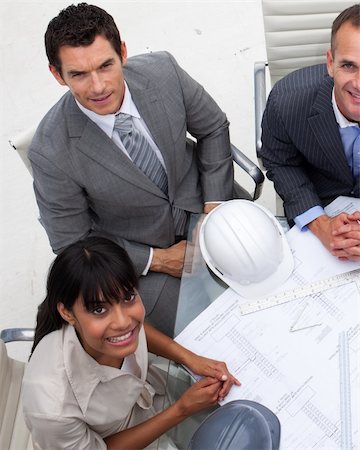 executives on table back - High angle of multi-ethnic architects working with blueprints in an office Stock Photo - Budget Royalty-Free & Subscription, Code: 400-04657474