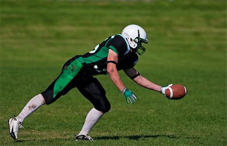 simsearch:400-04044185,k - A young, football player about to catch the ball. Stock Photo - Budget Royalty-Free & Subscription, Code: 400-04658656