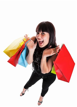 Smiling young woman, dressed Indie style, with shopping bags.  She is happy because of all the great sales!  Shot on white background with wide angle. Stock Photo - Budget Royalty-Free & Subscription, Code: 400-04658669