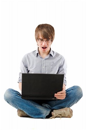 Young man surprised with laptop. Isolated over white Stock Photo - Budget Royalty-Free & Subscription, Code: 400-04658948