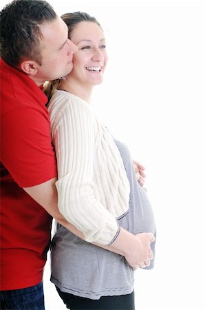pregnant women kissing - young family couple together in studio isolated on white. happy and waiting for baby Stock Photo - Budget Royalty-Free & Subscription, Code: 400-04659384