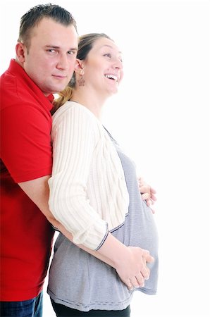 pregnant women kissing - young family couple together in studio isolated on white. happy and waiting for baby Stock Photo - Budget Royalty-Free & Subscription, Code: 400-04659383