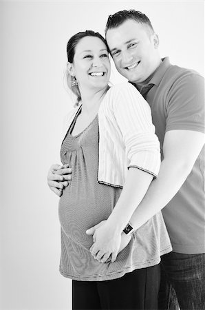 pregnant women kissing - young family couple together in studio isolated on white. happy and waiting for baby Stock Photo - Budget Royalty-Free & Subscription, Code: 400-04659392