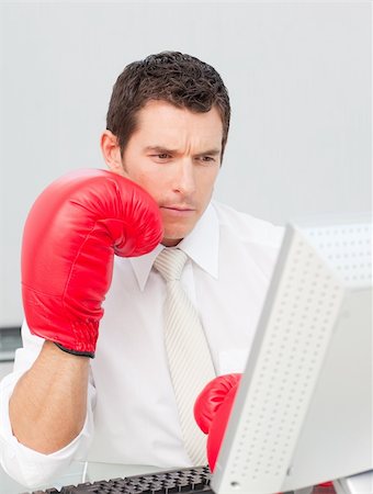 phone with pain - Businessman boxing himself in the face while he is working in the office Stock Photo - Budget Royalty-Free & Subscription, Code: 400-04659655