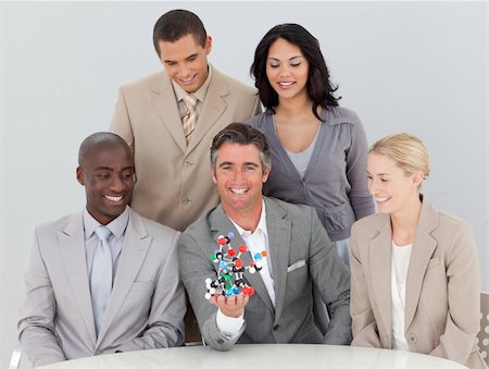 simsearch:400-05155599,k - Smiling multi-ethnic business team holding molecules in the office Stock Photo - Budget Royalty-Free & Subscription, Code: 400-04659711