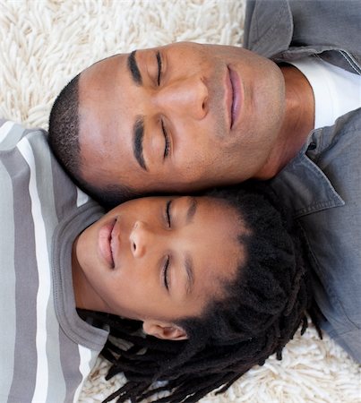 Portrait of Afro-American father and son sleeping on the floor at home Stock Photo - Budget Royalty-Free & Subscription, Code: 400-04659935