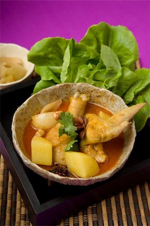 "Mas sa mhan kai" Thai Cuisine-A bowl of Thai yellow curry on a place mat Stock Photo - Budget Royalty-Free & Subscription, Code: 400-04650437