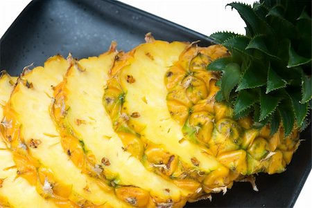 simsearch:400-04650758,k - ripe vibrant pineapple sliced on a black plate Stock Photo - Budget Royalty-Free & Subscription, Code: 400-04650757