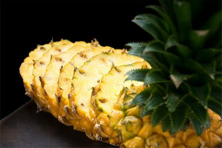simsearch:400-04650758,k - ripe vibrant pineapple sliced on a black plate Stock Photo - Budget Royalty-Free & Subscription, Code: 400-04650758