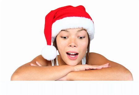 simsearch:400-04340435,k - Christmas girl with sign. Very beautiful mixed race asian / caucasian woman with billboard looking surprised down at the sign. Isolated on white background. Stock Photo - Budget Royalty-Free & Subscription, Code: 400-04650857