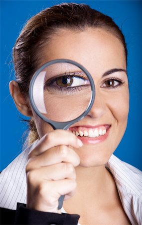 simsearch:400-04554899,k - Young and happy business woman looking through a magnifying Glass Stock Photo - Budget Royalty-Free & Subscription, Code: 400-04650959