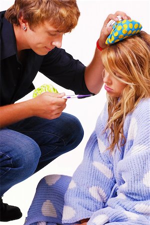 Teenage boy taking care of his sick girlfriend Stock Photo - Budget Royalty-Free & Subscription, Code: 400-04651038