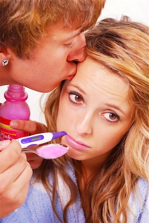 Teenage boy taking care of his sick girlfriend Stock Photo - Budget Royalty-Free & Subscription, Code: 400-04651040