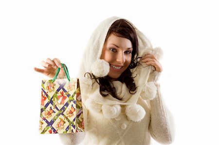 studio shot of cute brunette in white sweater showing a christmas shopping bag Stock Photo - Budget Royalty-Free & Subscription, Code: 400-04651772